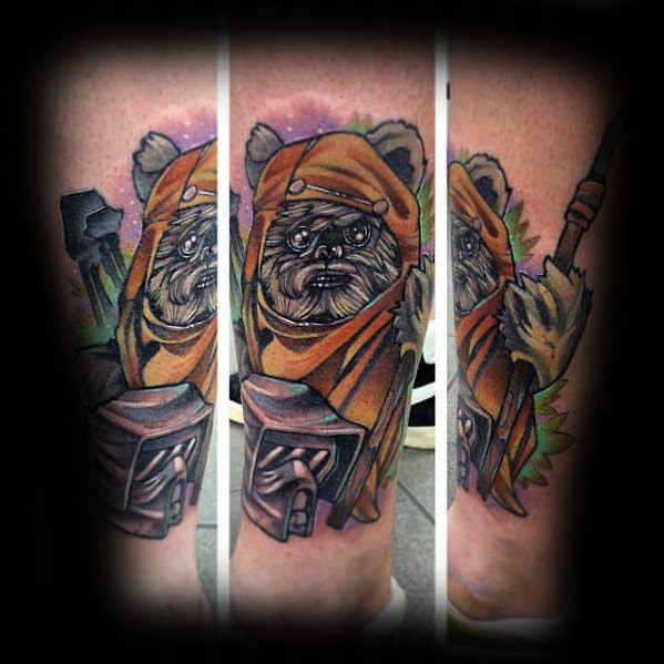 Detailed Ewok tattoo with orange hood, holding a spear and a carved wooden idol, set against a cosmic pink and green background.