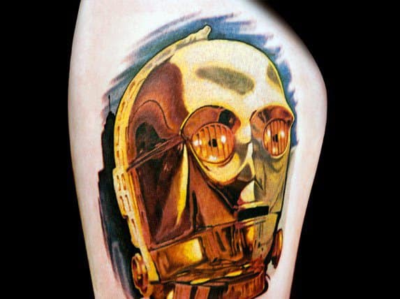 Hyper-realistic C-3PO tattoo with reflective gold detailing and vivid shading, creating a striking three-dimensional effect.