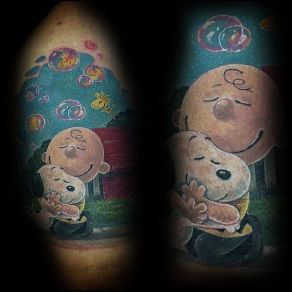 Vibrant Charlie Brown and Snoopy tattoo with a heartfelt hug, colorful bubbles, and Woodstock, capturing warmth, friendship, and nostalgia.