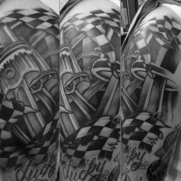 Detailed racing-themed tattoo featuring a piston, checkered flags, and bold shading, symbolizing speed, mechanics, and a passion for motorsports.