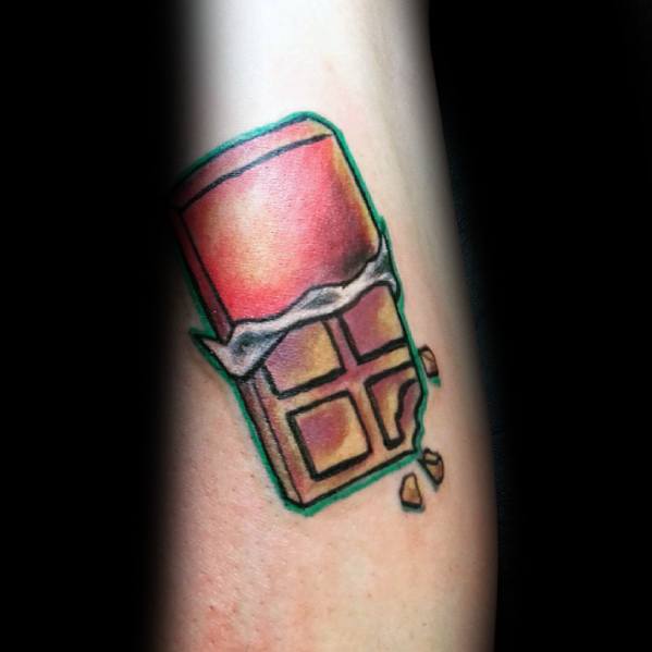 Colorful tattoo of a partially unwrapped chocolate bar with a green outline, featuring broken pieces for a dynamic and playful look.