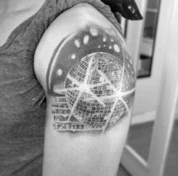 Realistic disco ball tattoo on the upper arm with glowing light reflections, creating a dynamic and bold design inspired by nightlife and music.