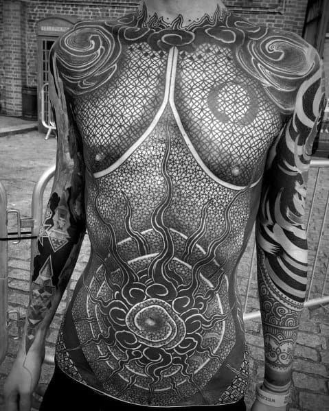 Black and grey full-torso tattoo featuring intricate geometric patterns, sacred symbols, and dotwork for a highly detailed and textured design.