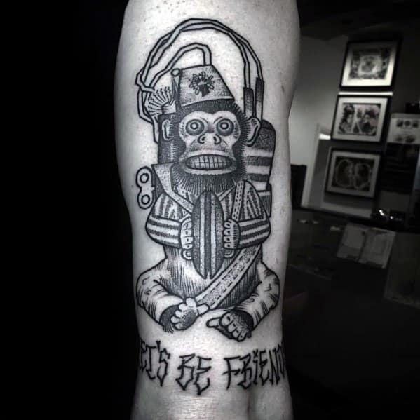 Bold black and grey Call of Duty Monkey Bomb tattoo on the forearm, featuring intricate details and the phrase "Let's Be Friends" below.