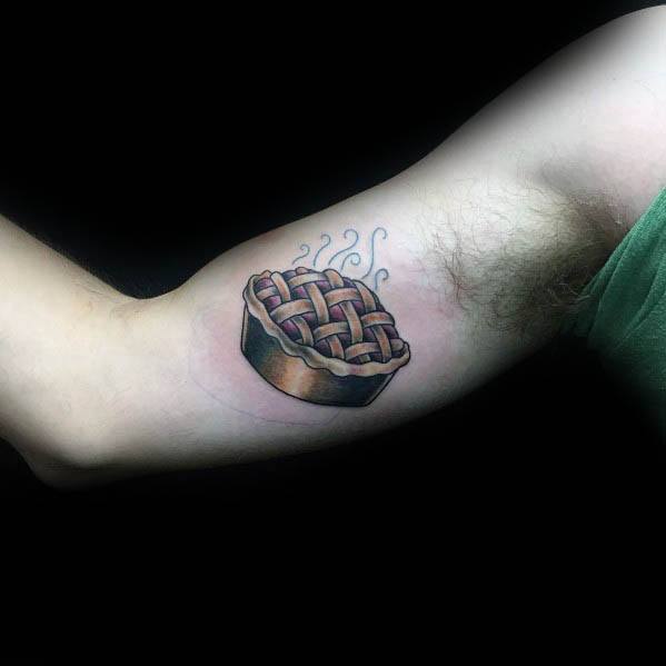 Classic steaming pie tattoo with a lattice crust, placed on the inner arm, symbolizing warmth, home, and a love for baked goods