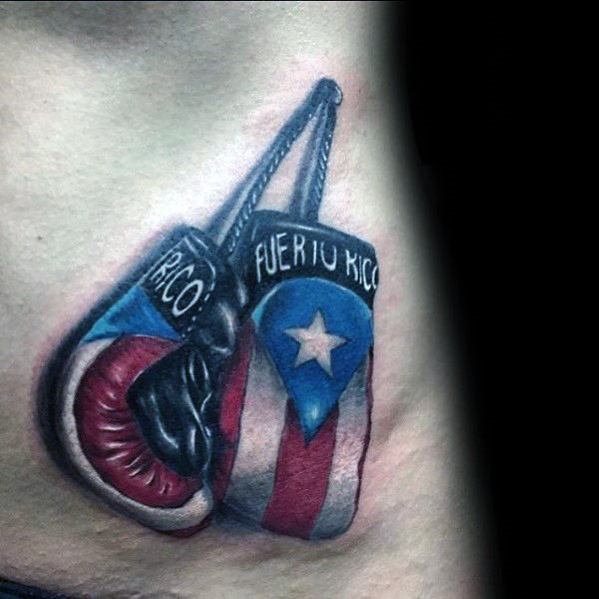 Puerto Rican flag tattoo featuring boxing gloves, symbolizing strength, resilience, and national pride in a bold and dynamic design.