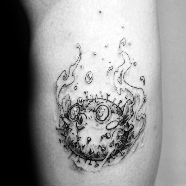 Black and grey pufferfish tattoo with a surreal, smoky design and fine line details, giving it a unique and artistic underwater feel.