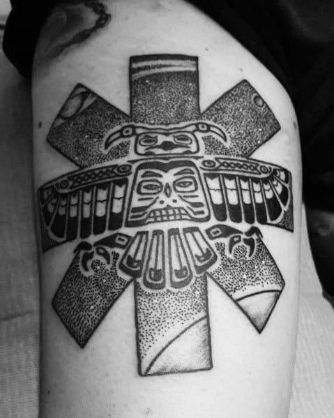 Tattoo featuring the Red Hot Chili Peppers logo combined with a bold tribal totem design, using intricate dotwork and black ink detailing.