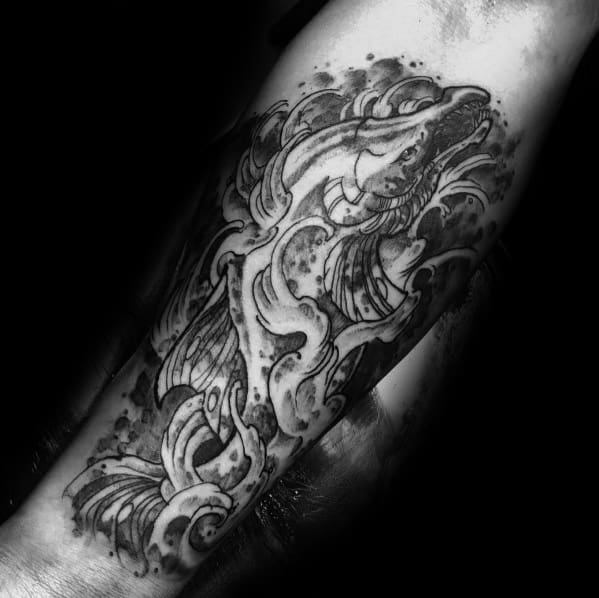 Black and grey tattoo of a salmon swimming through dynamic waves, featuring intricate shading and bold details for a powerful, fluid design.