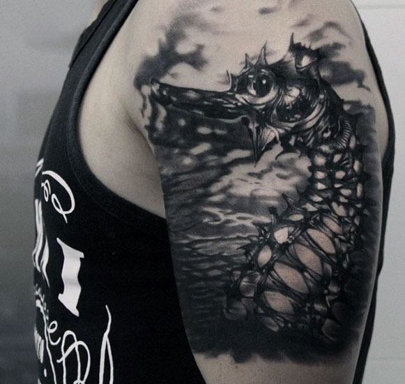 Dark surreal seahorse tattoo on upper arm, featuring intricate shading, a skeletal design, and a stormy ocean backdrop for a bold, dramatic look.