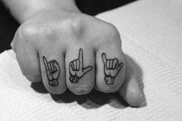 black ink tattoo of ASL hand signs spelling "ILY" on the fingers, using a simple line design for a bold and meaningful look