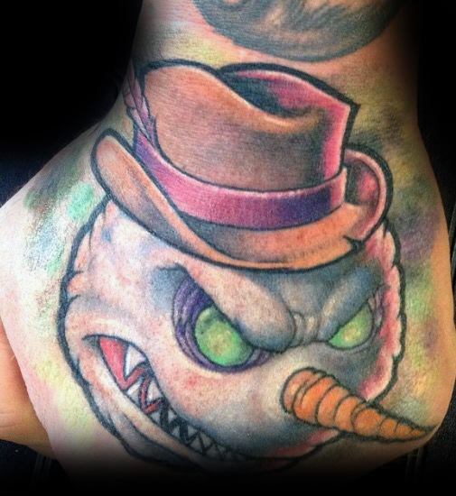 Menacing snowman tattoo with glowing green eyes, sharp teeth, a tilted hat, and a twisted grin, blending horror and winter themes.