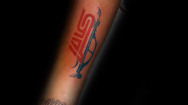 Subaru STI-themed tattoo on the forearm featuring the bold red STI logo paired with a sleek, stylized blue exhaust design.
