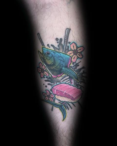 Colorful tuna sushi tattoo on a man's leg, featuring vibrant hues, chopsticks, flowers, and bold outlines for a unique and playful design.