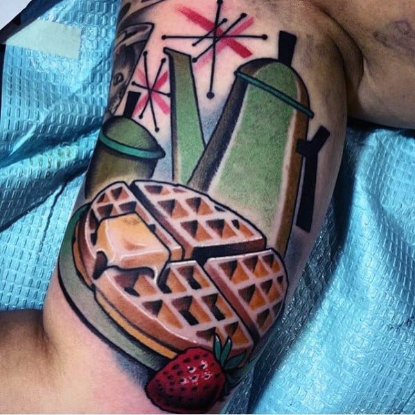 Retro-style waffle tattoo featuring syrup, butter, a strawberry, and vintage coffee pots with atomic starbursts, creating a nostalgic diner vibe.