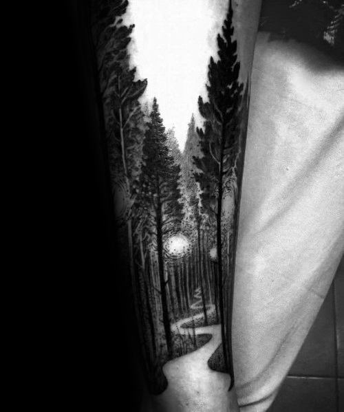 Black ink forest tattoo on the leg, featuring tall pine trees, a winding path, and glowing lights for a mysterious and serene woodland scene.