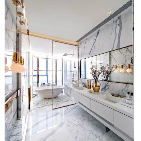 Luxurious white marble bathroom featuring a large mirror, modern fixtures, and a freestanding tub