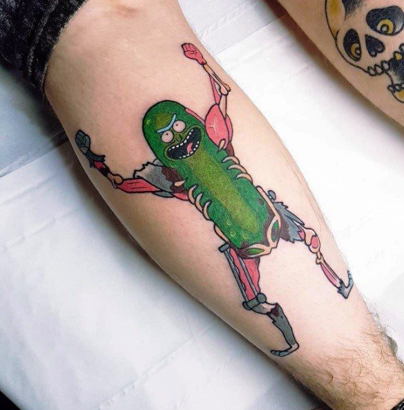 Pickle Rick tattoo in cyborg form, featuring detailed biomechanical limbs and a fierce expression, placed on the lower leg.