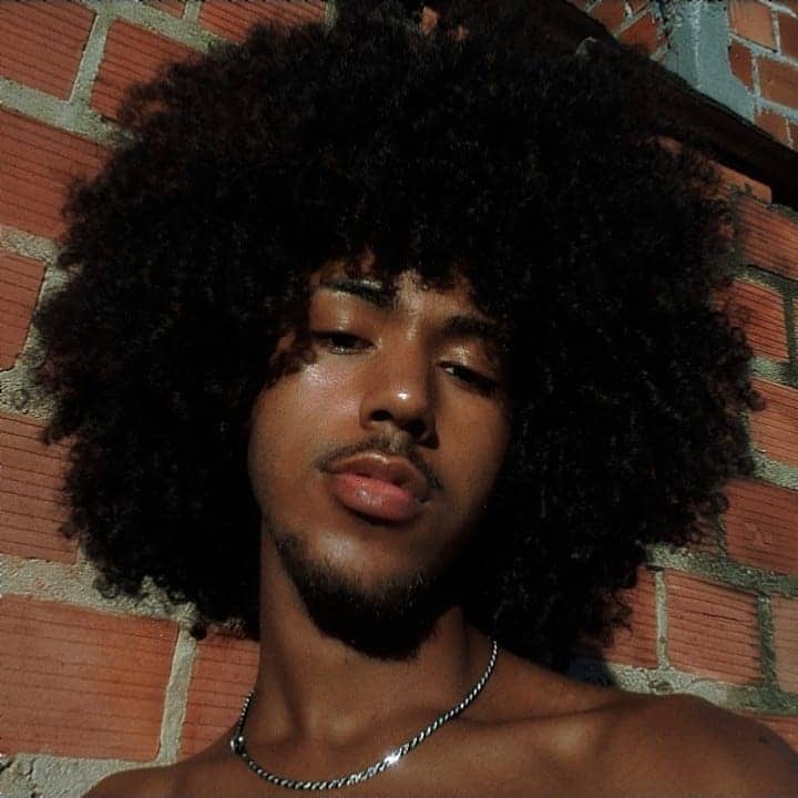 A beautiful extended afro styled on type 3C curly hair. The hairstyle has a lot of texture and movement