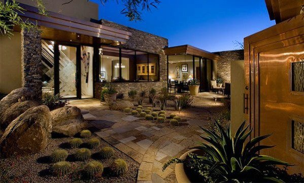 luxurious backyard with stone pathway and cactus plants