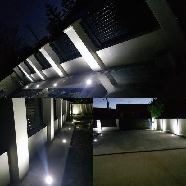 Driveway with modern wall lighting casting soft glows along the path, creating a stylish and well-lit entrance