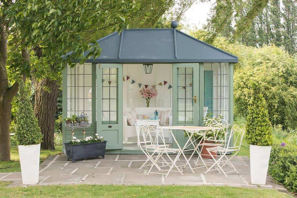 green exterior she shed with cement patio 