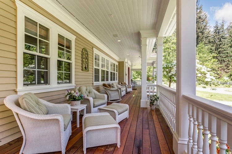 exterior white window wood trim wood patio white wicker furniture 