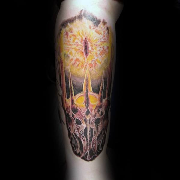 Tattoo of a fiery Eye of Sauron above a medieval helmet with tall, pointed spikes