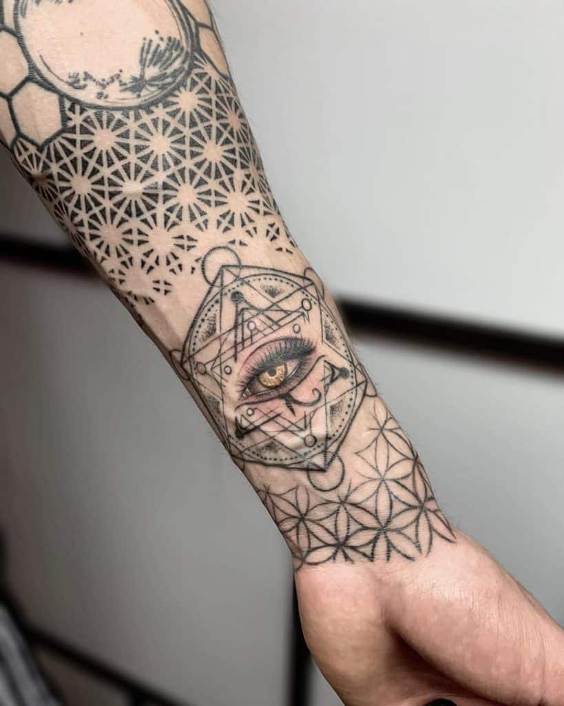 Forearm tattoo with an intricate geometric pattern, a detailed realistic eye, and sacred shapes, blending mysticism with modern design.