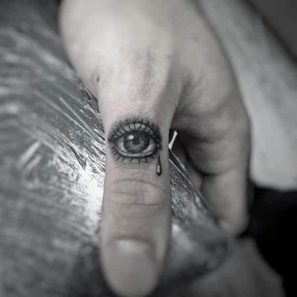 Eye With Tear Drop Thumb Tattoo On Male
