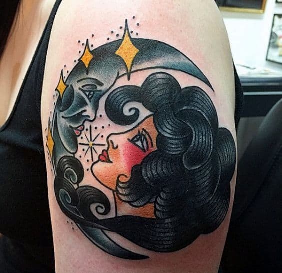 Traditional tattoo of a gypsy woman gazing at a crescent moon with a face, featuring bold black hair, golden stars, and vibrant shading on the upper arm.