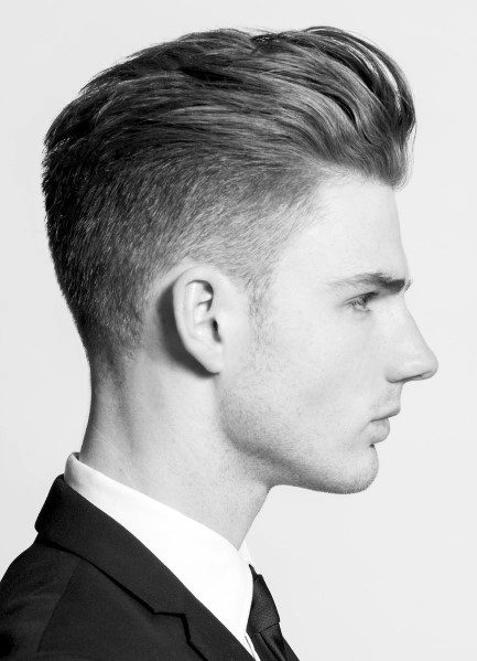 Sleek, combed-back look with a mid-fade on the sides and back