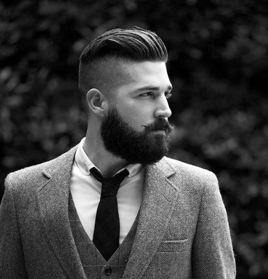 Man with a slicked-back undercut and full beard