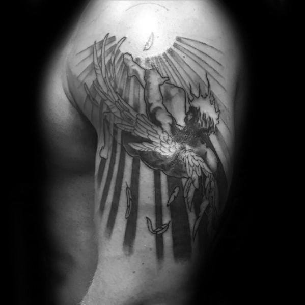 Realistic tattoo of Icarus falling with wings melting as he reaches toward the sun, inked on the upper arm and shoulder.