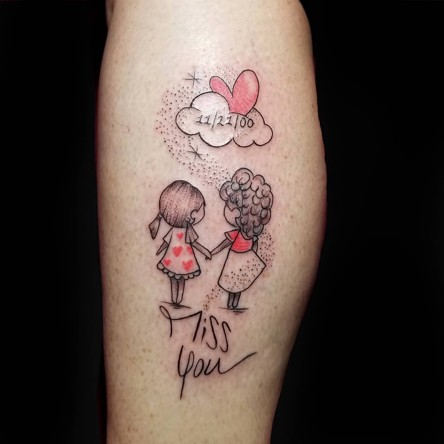Tattoo of two girls holding hands, hearts, a cloud with "11/2/00," and the words "miss you" in cursive