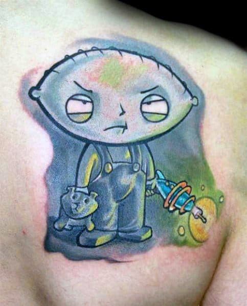 Tattoo of Stewie Griffin from Family Guy with an intense expression, holding his teddy bear and a glowing futuristic ray gun, set against a smoky backdrop.