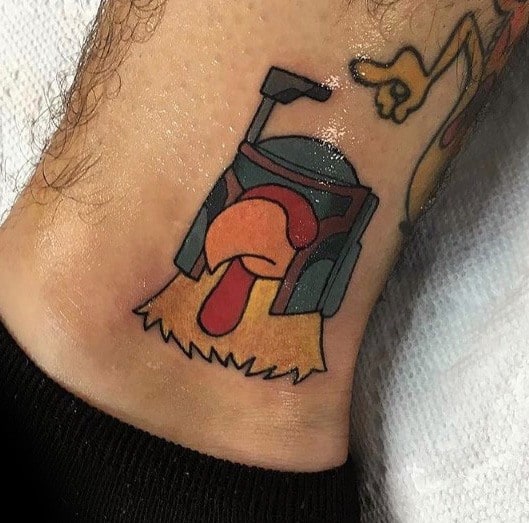 Tattoo of the Giant Chicken from Family Guy wearing Boba Fett’s helmet, combining Star Wars and cartoon elements in a colorful design.