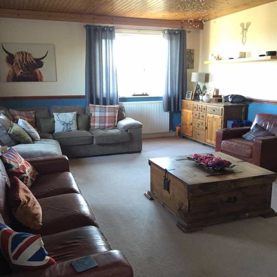 family room gray and tan sofas wood coffee table chest