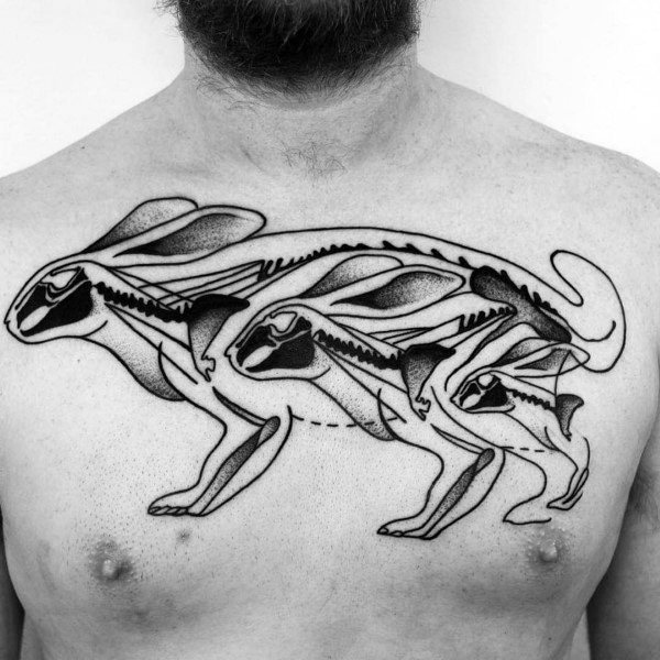 Black ink chest tattoo of three running rabbits with stylized skeletal anatomy, layered in dynamic motion across the torso.