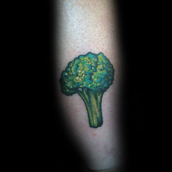 Small realistic broccoli tattoo on the forearm, featuring rich green tones and fine shading for a simple yet eye-catching design.