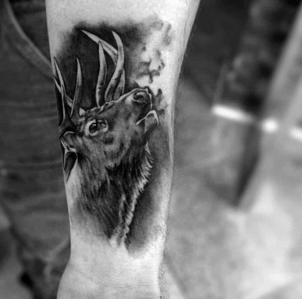 Realistic black and grey elk tattoo on the forearm, featuring fine shading and breath detail for a bold and lifelike design.