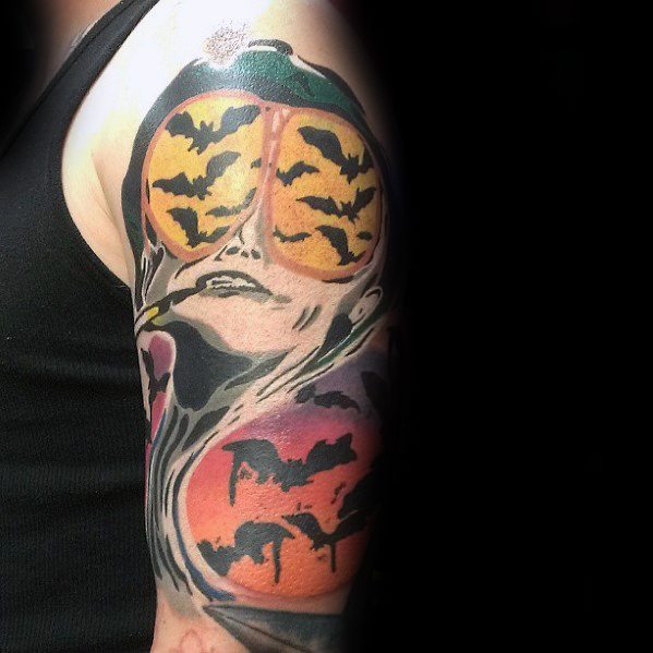 Surreal Hunter S. Thompson tattoo featuring aviator glasses reflecting bats, a melting face, and a desert landscape with bold colors and shading.