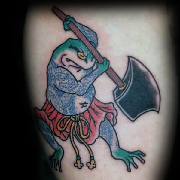 Japanese-style tattoo of a warrior frog gripping a large axe, dressed in a red loincloth with intricate patterns, symbolizing strength and determination.