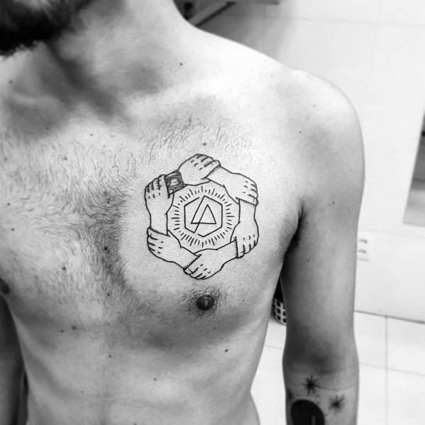 Black ink chest tattoo featuring the Linkin Park logo encircled by interlocked hands, symbolizing unity and connection.