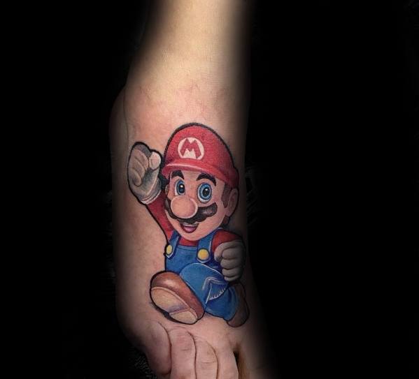 Detailed Mario tattoo on the foot, featuring bright colors and dynamic motion, capturing the classic video game character in an action pose.