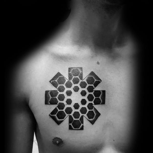 Chest tattoo featuring the Red Hot Chili Peppers logo with a 3D honeycomb pattern, creating a bold and textured geometric effect.