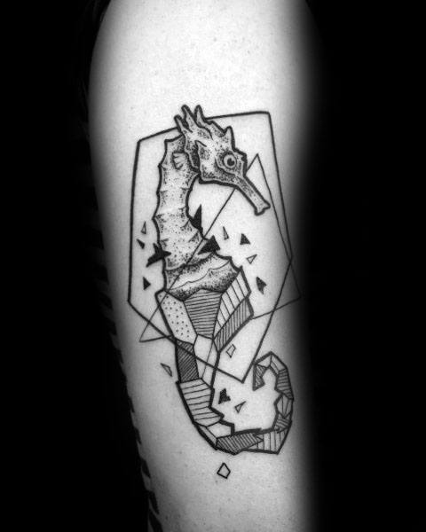 Abstract seahorse tattoo on arm, featuring geometric shapes, fine linework, and a fragmented design for a modern, artistic look.