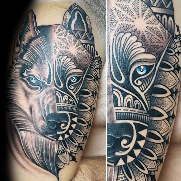 Half-realistic, half-geometric Siberian Husky tattoo on a man's upper arm, featuring intricate mandala patterns and striking blue eyes.