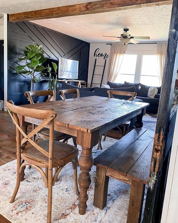 Farmhouse-inspired dining room with rustic wooden table, bench, and cozy boho accents.