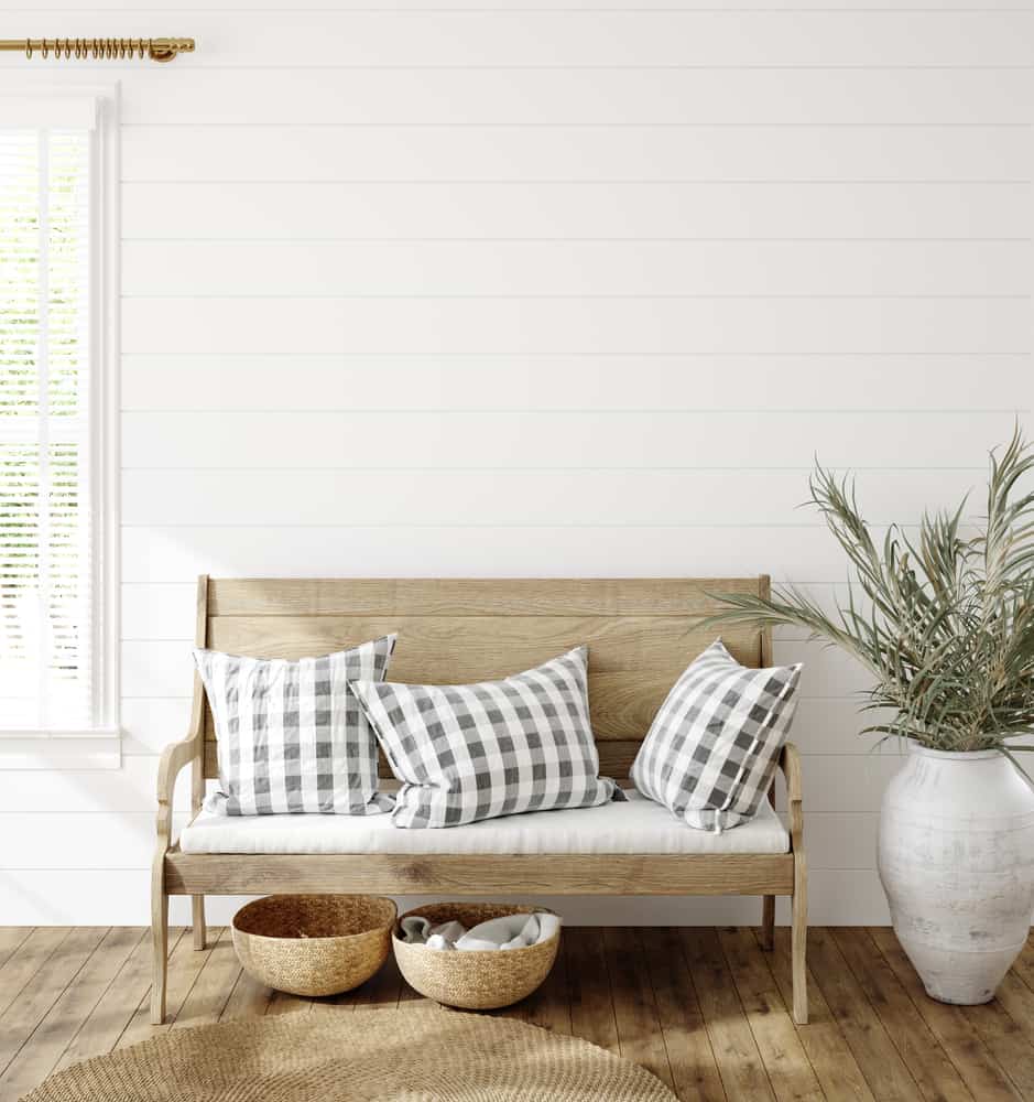 white shiplap walls wood bench wood floors living room 